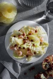 Photo of Delicious salad with Chinese cabbage, shrimps and pineapple served on grey table, flat lay