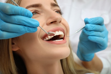 Doctor examining patient's teeth, closeup. Cosmetic dentistry