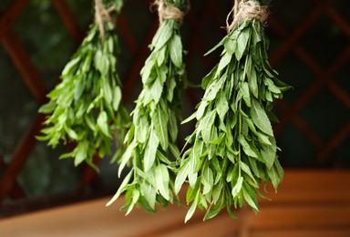 Photo of Bunches of beautiful green mint hanging outdoors
