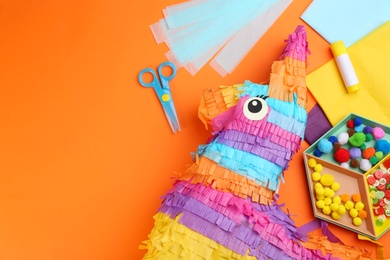 Flat lay composition with cardboard donkey on orange background, space for text. Pinata diy