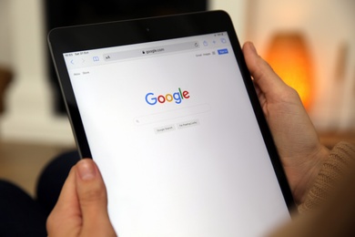 MYKOLAIV, UKRAINE - OCTOBER 31, 2020: Woman using Google search engine on tablet indoors, closeup