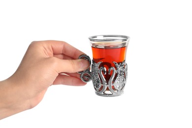 Woman holding glass of traditional Turkish tea in vintage holder on white background, closeup