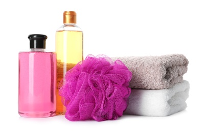 Personal hygiene products with towels and shower puff on white background