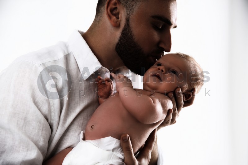 Father with his newborn baby on white background