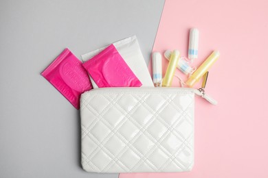 Tampons, pads and bag on color background, flat lay
