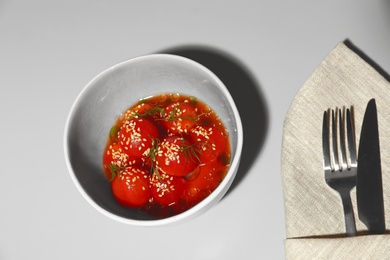 Photo of Tasty soup with blanched tomatoes on light table, above view