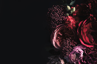 Beautiful bouquet of different flowers on black background, space for text. Floral card design with dark vintage effect