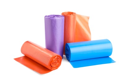 Rolls of different color garbage bags isolated on white
