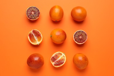 Many ripe sicilian oranges on orange background, flat lay