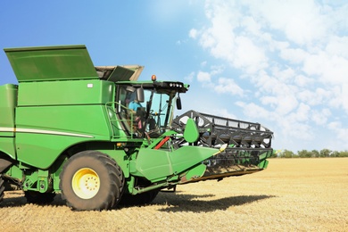 Modern combine harvester in field. Agricultural industry