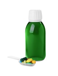 Photo of Bottle of syrup, plastic spoon with pills on white background. Cough and cold medicine