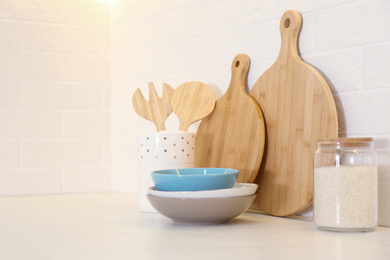 Wooden boards and different kitchen items on countertop indoors