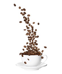 Aromatic roasted coffee beans falling into cup on white background