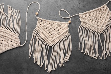 Stylish beige macrame on grey table, top view
