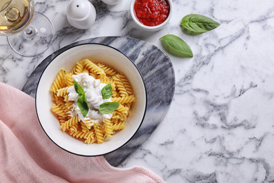 Delicious pasta with sauce served on white marble table, flat lay