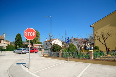Road sign STOP on outdoor car parking lot