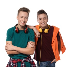 Teenage twin brothers with headphones on white background