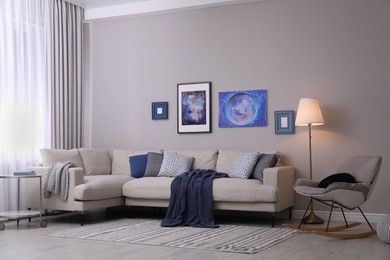 Stylish sofa in modern living room interior