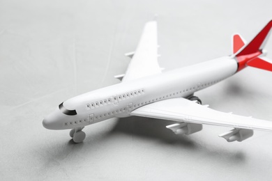 Photo of Toy airplane on grey stone background, closeup