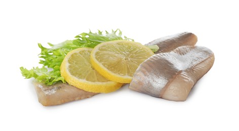 Delicious salted herring fillets with lettuce and lemon slices on white background
