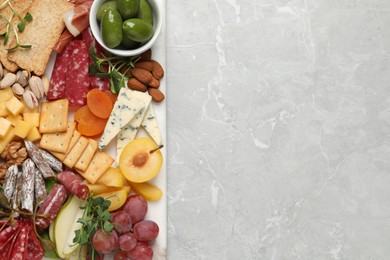 Photo of Different tasty appetizers on light marble table, top view. Space for text