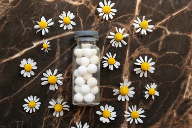 Photo of Bottle of homeopathic remedy and beautiful chamomiles on textured background, flat lay