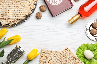 Flat lay composition with symbolic Passover (Pesach) items on wooden background, space for text
