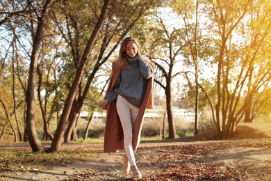 Beautiful young woman wearing stylish clothes in autumn park