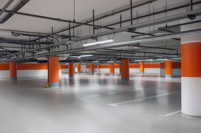 Photo of Empty car parking garage with lighting and columns
