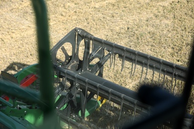 Modern combine harvester in agricultural field, closeup view of reel