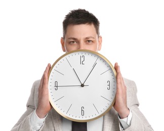 Businessman holding clock on white background. Time management