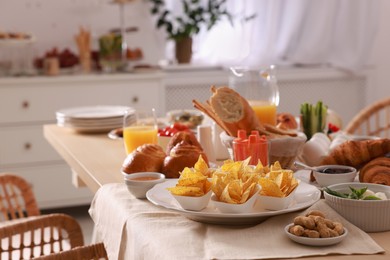 Dishes with different food on table in room. Luxury brunch