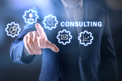 Consulting concept. Businessman pointing on dark background, closeup