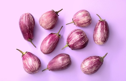 Photo of Raw ripe eggplants on light background, flat lay