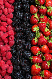 Mix of different ripe tasty berries as background, top view