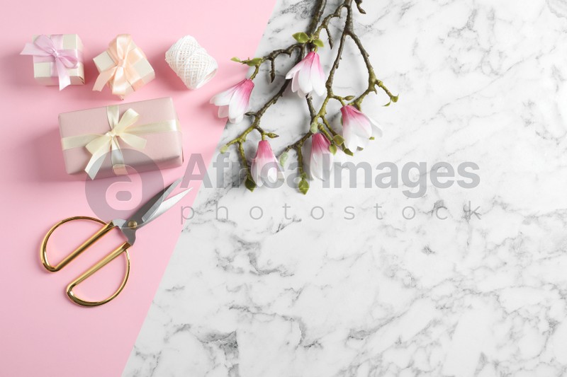 Flat lay composition with scissors, gifts and spring flowers on color background, space for text