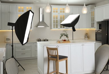 Photo of Professional photo studio equipment prepared for shooting kitchen interior