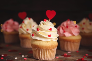 Tasty sweet cupcakes on wooden table. Happy Valentine's Day