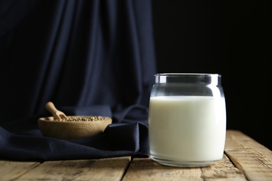 Jar of hemp milk on wooden table
