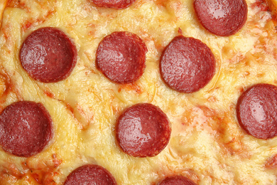 Tasty pepperoni pizza as background, top view