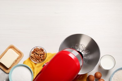 Photo of Modern red stand mixer and different ingredients on white wooden table, flat lay. Space for text