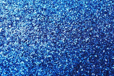 Beautiful shiny blue glitter as background, closeup