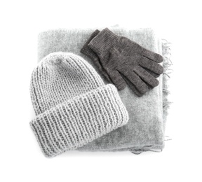 Woolen gloves, scarf and hat on white background, top view