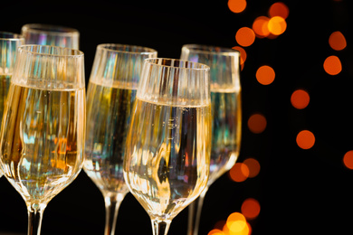 Glasses of champagne against blurred lights, closeup