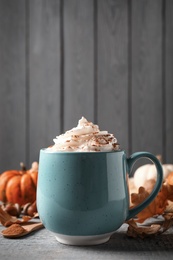Delicious pumpkin latte on grey wooden table