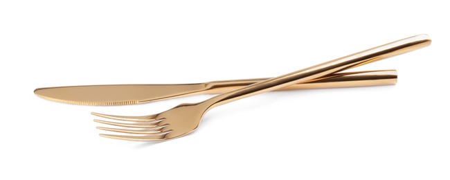 Golden fork and knife on white background