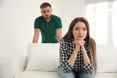 Unhappy young couple with relationship problems at home
