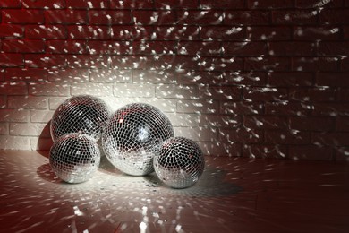Photo of Many shiny disco balls indoors, color toned. Space for text