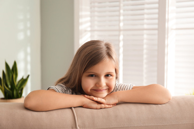 Cute little girl on couch at home