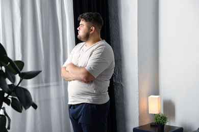 Overweight man suffering from depression at home
